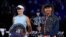 Japan's Naomi Osaka, right, holds the Daphne Akhurst Memorial Cup defeating American Jennifer Brady, left, in the women's singles final at the Australian Open tennis championship in Melbourne, Australia, Feb. 20, 2021.