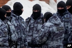 FILE —Riot police officers guard the area near the Church of the Icon of the Mother of God Soothe My Sorrows, in Moscow, Russia, March 1, 2024.