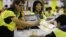 Electoral officers count ballots at the central ballot counting station after legislative elections in Hong Kong, Monday, Sept. 10, 2012.