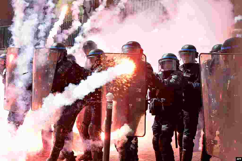 Police stand in formation as they clash with protesters at a traditional May Day demonstration in Paris, France.