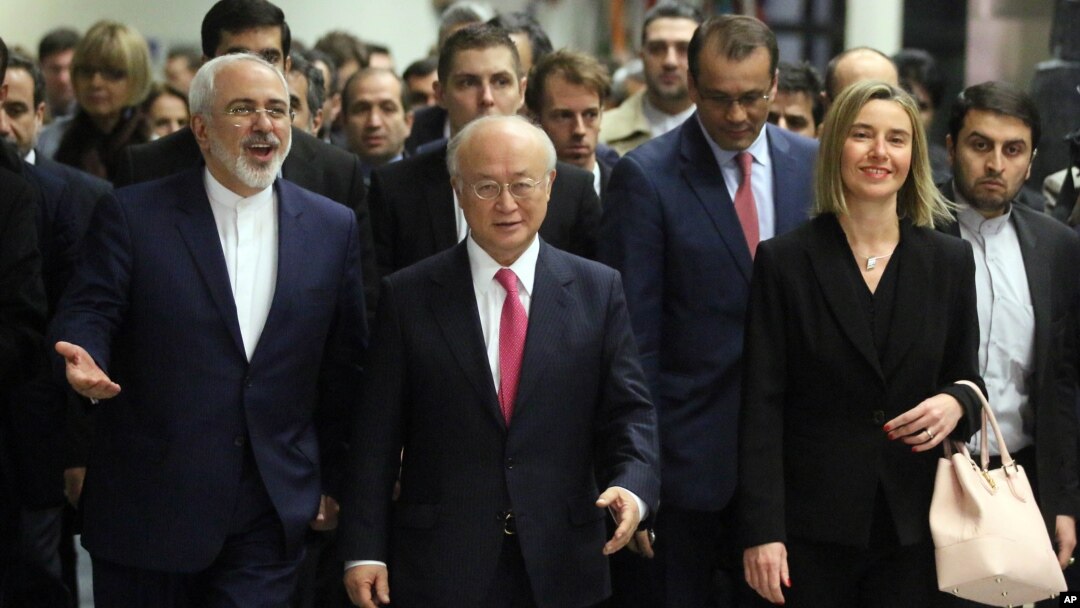 Iranian Foreign Minister Mohammad Javad Zarif, left, Director General of the International Atomic Energy Agency, IAEA, Yukiya Amano of Japan and European Union High Representative Federica Mogherini, right, arrive at the International Atomic Energy Agency