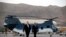 FILE - Secretary of State Mike Pompeo walks from a helicopter with U.S. Ambassador to Afghanistan John Bass, as Pompeo returns to his plane after an unannounced visit to Kabul, Afghanistan, June 25, 2019.