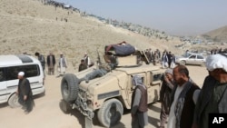 Afghan security police patrol near the cemetery, where victim of Friday's suicide attack at the Shi'ite mosque were buried, in Kabul, Afghanistan, Saturday, Oct. 21, 2017.