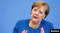 German Chancellor Angela Merkel gestures as she addresses a news conference on coronavirus in Berlin, Germany, March 11, 2020. REUTERS/Michele Tantussi