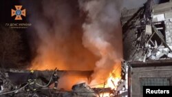 FILE - Firefighters work at the site where a building was damaged by a Russian drone strike, amid Russia's attack on Ukraine, in Zaporizhzhia region, Ukraine November 18, 2023.