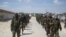 FILE - Members of Somalia's al-Shabab militant group march on the outskirts of Mogadishu, Somalia, March, 5, 2012. 