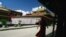 FILE - A Tibetan monk walks along the halls of the Jokhang Buddhist temple in Lhasa, Tibet.