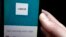 FILE - An Uber app is displayed on a phone in London, Sept. 22, 2017.