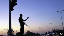 Libyan special emergency police officer controls traffic in the rebel-held Benghazi, Libya. The new police unit was founded by the Libyan interim government National Council in early June, Tuesday, July 12, 2011