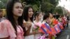 Women hold Cambodian and Chinese flags for welcoming Chinese President Hu Jintao in front of the Royal Palace in Phnom Penh, Cambodia, March 31, 2012.