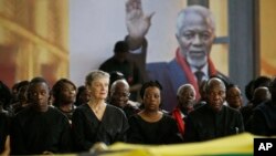 Kofi Annan's son Kojo Annan, left, widow Nane Annan, 2nd left, and daughter Ama Annan, center, join other family members to pay their respects as the coffin of former U.N. Secretary-General Kofi Annan lies in state at the Accra International Conference Center in Ghana Wednesday, Sept. 12, 2018. Ghanaians are paying their respects to Annan, who died in August in Switzerland at age 80, ahead of Thursday's state funeral. 