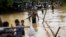 Rohingya Muslims cross a flooded area to find an alternate shelter after their camp was inundated with rainwater near Balukhali refugee camp, Bangladesh, Sept. 19, 2017. 