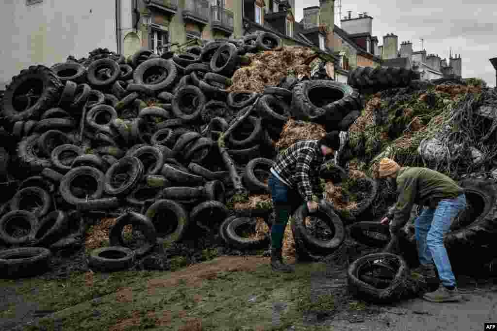 Farmers dump manure and tires near the Burgundy prefecture to protest against the consequences of government censorship and EU-Mercosur agreement, in Dijon, central eastern France.