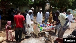 FILE - People wait to get food distributed by volunteers in Omdurman, Sudan, on Sept. 3, 2023.