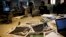 FILE - Egyptian journalists work in the editorial room of the Al-Masry Al-Youm daily newspaper next to copies of Egypt’s most prominent newspapers in Cairo, Egypt, Dec. 3, 2012. 