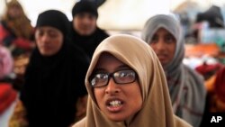 Nurshardrina Khairadhinia, 19, from Indonesia, the cousin of a young man suspected of being a member of so-called Islamic State (IS), speaks during an interview with the Associated Press, inside their tent at a refugee camp, in Ain Issa, Syria; July 24, 2017.