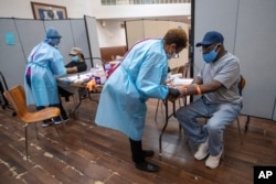 Nurses draw blood from patients during a COVID-19 antibody test drive at the Abyssinian Baptist Church, in the Harlem neighborhood of the Manhattan borough of New York.