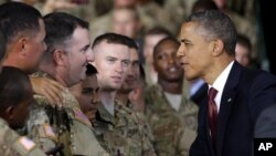 President Barack Obama (R) greets members of the military before speaking at Fort Bliss, Texas, August 31, 2012.