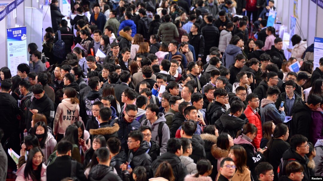 FILE - Students are seen at a job fair for graduates at a university in Shenyang, Liaoning province, China, March 21, 2019. 