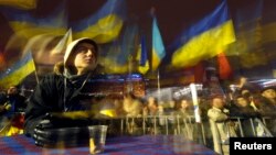 Pro-European integration protestors wave flags in Independence Square in Kyiv, Ukraine, Dec. 12, 2013.