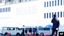 The 3,700 people on board the Diamond Princess face a two-week quarantine in their cabins, Feb. 6, 2020, at Yokohama, south of Tokyo. Health workers said 10 more people from the ship have the virus, in addition to 10 who tested positive Wednesday.