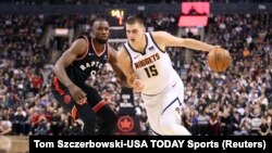 Nikola Jokic des Denver Nuggets face à Serge Ibaka des Raptors, Toronto, Canada, le 3 décembre 2018. (Tom Szczerbowski-USA TODAY Sports) 