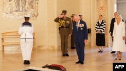 Britain's King Charles III and Queen Camilla stand after laying a wreath at the Australian War Memorial in Canberra on October 21, 2024.