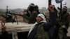 Turkish-backed Syrian fighters are pictured in the back of their trucks as they leave their barracks in the rebel-held border town of Jarabulus on December 25, 2018, as they prepare to move towards Manbij.