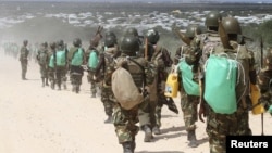 FILE - African Union Mission in Somalia (AMISOM) peacekeepers from Burundi patrol after fighting between insurgents and government soldiers erupted on the outskirts of Mogadishu, May 22, 2012.