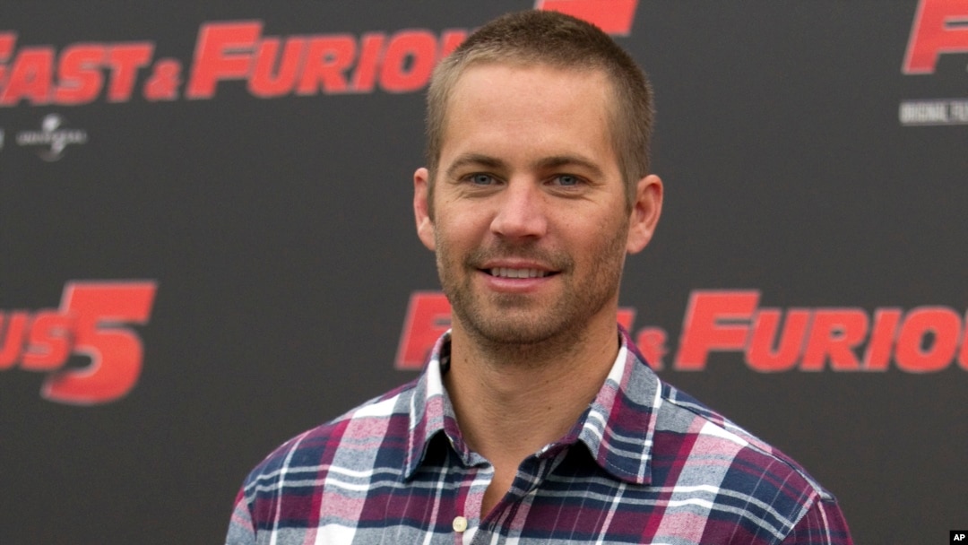 FILE - In this April 29, 2011 file photo, actor Paul Walker poses during the photo call of the movie "Fast and Furious 5," in Rome. 