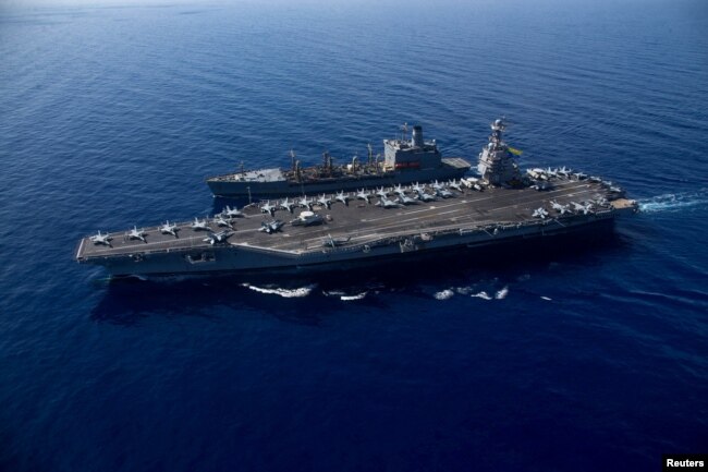 FILE - The world's largest aircraft carrier USS Gerald R. Ford steams alongside USNS Laramie (T-AO-203), taken on October, 11, 2023 and released by U.S. Navy on October 14, 2023. (U.S Naval Forces Central Command / U.S. 6th Fleet / Handout via REUTERS/File Photo)