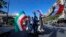 Hundreds of Syrians flash victory signs, honk car horns and wave Syrian, Iranian and Russian flags as they chant slogans against U.S. President Trump in Damascus, Syria, April 14, 2018.