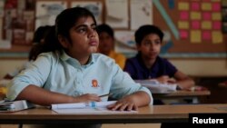 FILE - Students attend class at the Headstart private school in Islamabad, Pakistan, Oct. 9, 2017. 
