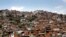 FILE - A hill covered with low-income houses is seen in Petare district, Caracas, March 6, 2014.
