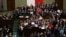 Polish opposition parliamentarians protest against the rules proposed by the head office of the lower house of parliament that would ban all recording of parliamentary sessions except by five selected television stations and limits the number of journalists allowed in building.