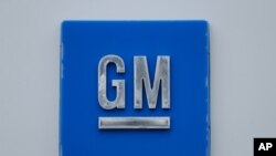 FILE - In this Jan. 27, 2020 file photo, a GM logo is shown at the General Motors Detroit-Hamtramck Assembly plant in Hamtramck, Mich. 