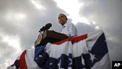 U.S. President Barack Obama is pictured as the sun breaks through clouds at a town hall-style event in Alpha, Illinois, August 17, 2011