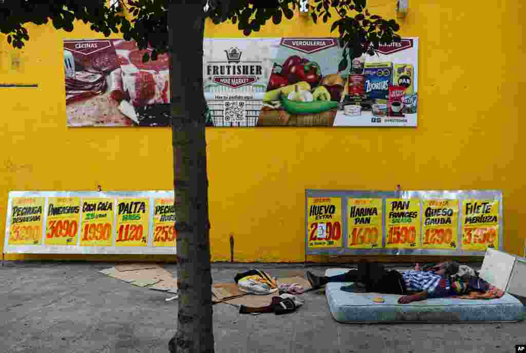 칠레 산티아고의 식료품점 앞에서 노숙자가 매트리스에 누워 자고 있다. 유엔 보고서에 의하면 남미 국가들은 6억명이 넘은 인구가 먹을 식량을 충분히 비축하고 있음에도 불구하고, 지난해 1.91억명이 영양부족, 4천7백만명이 기아를 겪었다.