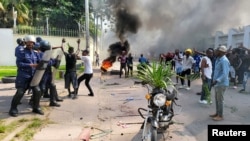 Protesters clash with riot police forces in front of the French Embassy in Kinshasa, Democratic Republic of Congo, Jan. 28, 2025. 