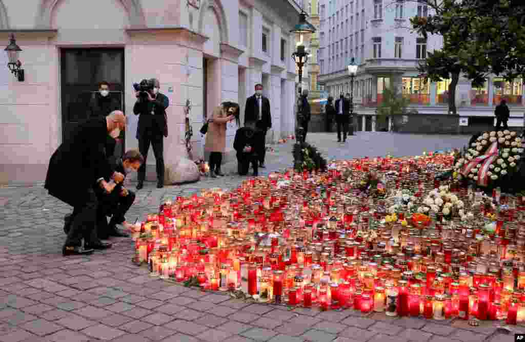 President of the European Council Charles Michel, left, and Austrian Chancellor Sebastian Kurz, right, pay tributes to those killed in the recent terror attack, in Vienna, Austria.