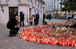 President of the European Council Charles Michel, left, and Austrian Chancellor Sebastian Kurz, right, pay respect to those killed in the t terror attack, in Vienna, Austria, Nov. 9, 2020.