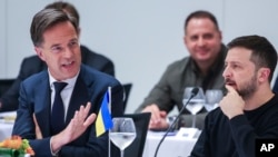 NATO Secretary General Mark Rutte, left, speaks with Ukrainian President Volodymyr Zelenskyy during the NATO-Ukraine Council working dinner at NATO headquarters in Brussels on Oct. 17, 2024.