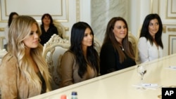 U.S. television personalities Kim Kardashian, second left, and Khloe Kardashian, left, meet with Armenian Prime Minister Hovik Abrahamyan in Yerevan, Armenia, April 9, 2015.