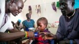 A medical officer from Doctors Without Borders (MSF) attends to a child with malnutrition in a clinic in Old Fangak, Jonglei state, on Aug. 18, 2017. 