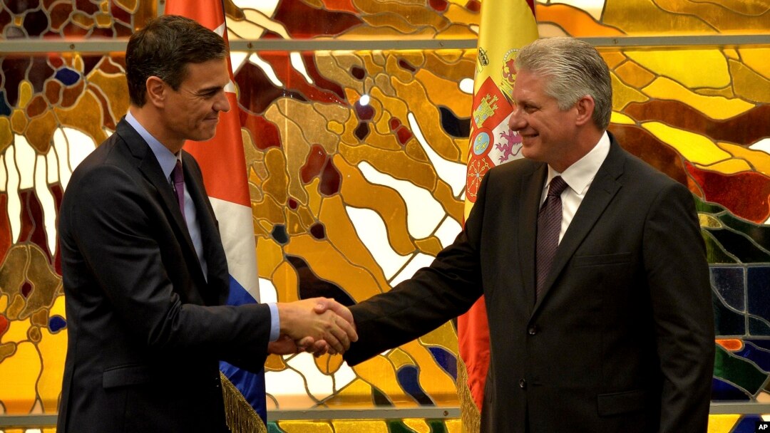 FILE - Spain's Prime Minister Pedro Sanchez, left, and Cuba's President Miguel Diaz-Canel shake hands at the Palace of The Revolution in Havana, Cuba, Nov. 22, 2018. 