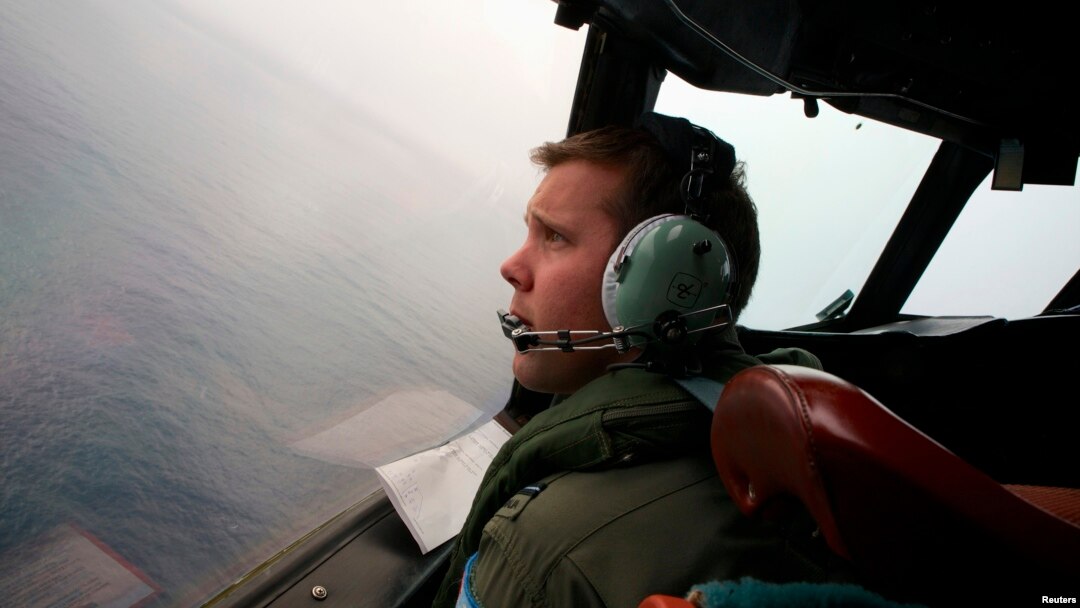 Co-Pilot, Flying Officer Marc Smith, turns his Royal Australian Air Force (RAAF) AP-3C Orion aircraft at low level in bad weather whilst searching for the missing Malaysian Airlines Flight MH370 over the southern Indian Ocean, March 24, 2014.