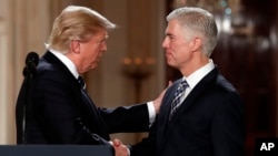 President Donald Trump shakes hands with 10th U.S. Circuit Court of Appeals Judge Neil Gorsuch, his choice for Supreme Court associate justice in the East Room of the White House in Washington, Jan. 31, 2017. 