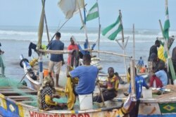 Ghana’s coastline is dotted with canoes and the local fishing industry which rely on them. (S. Knott for VOA)