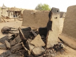 FILE - A destroyed home is seen on June 11, 2019, in the Dogon village after an attack that killed on ethnic Dogon on June 9, 2019.
