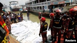 Rescue members bring bodies of victims on a boat after a passenger ferry capsized in the river Buriganga in Dhaka, Bangladesh, June 29, 2020. 